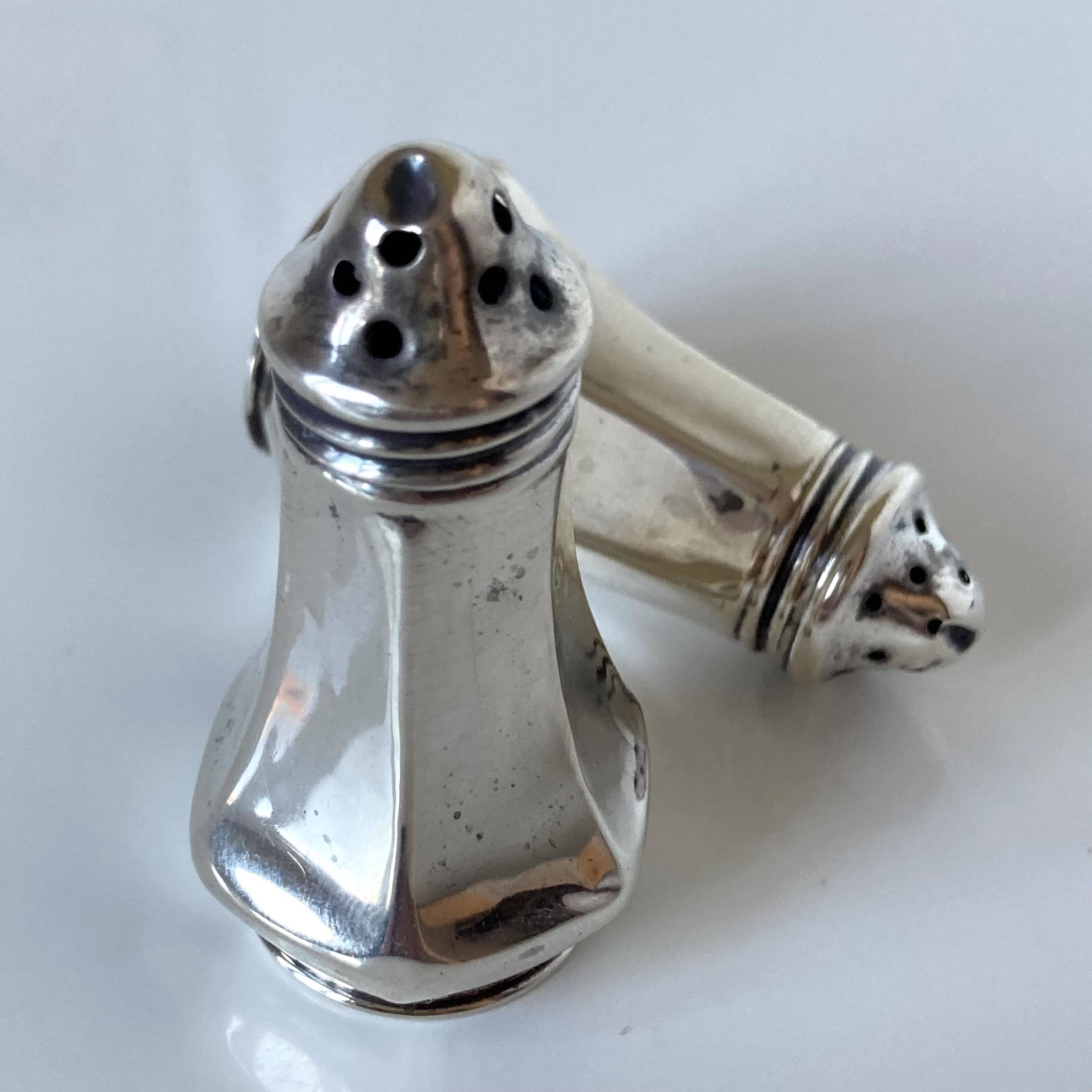 Antique salt and pepper shakers in solid English silver