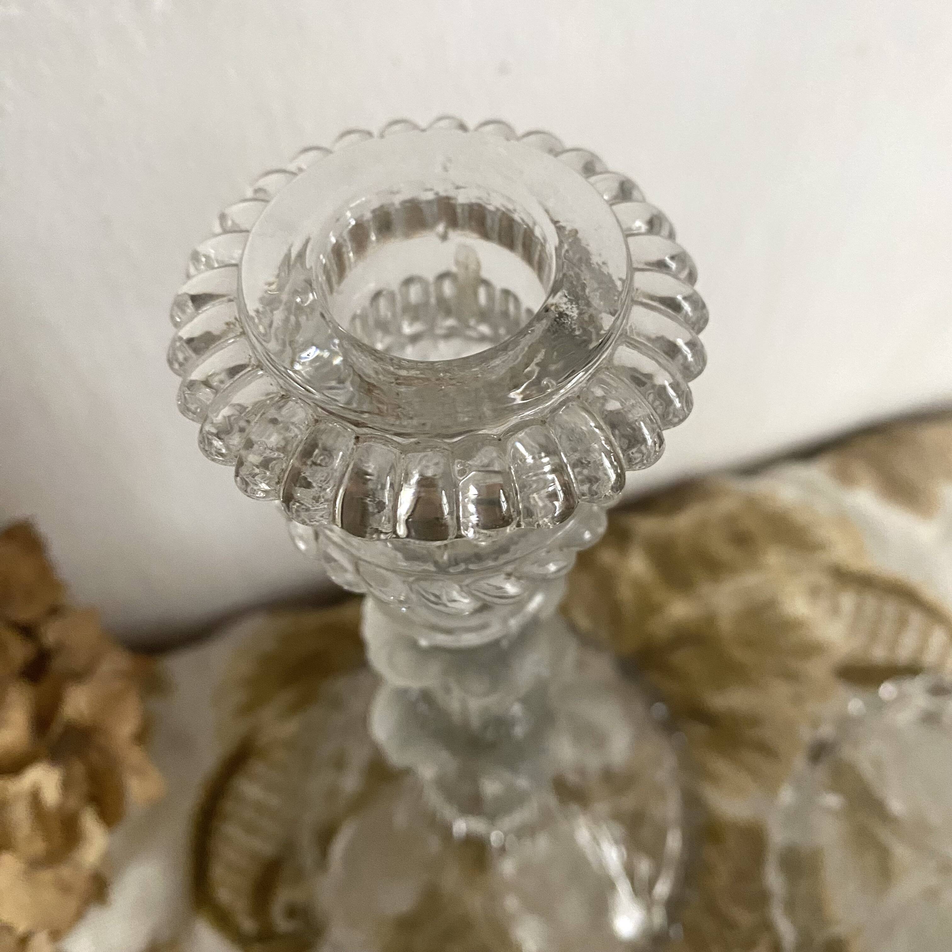 Pair of moulded glass candlesticks, ram heads and masks