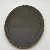 Antique oval gilded mirror with wooden frame and stucco detail
