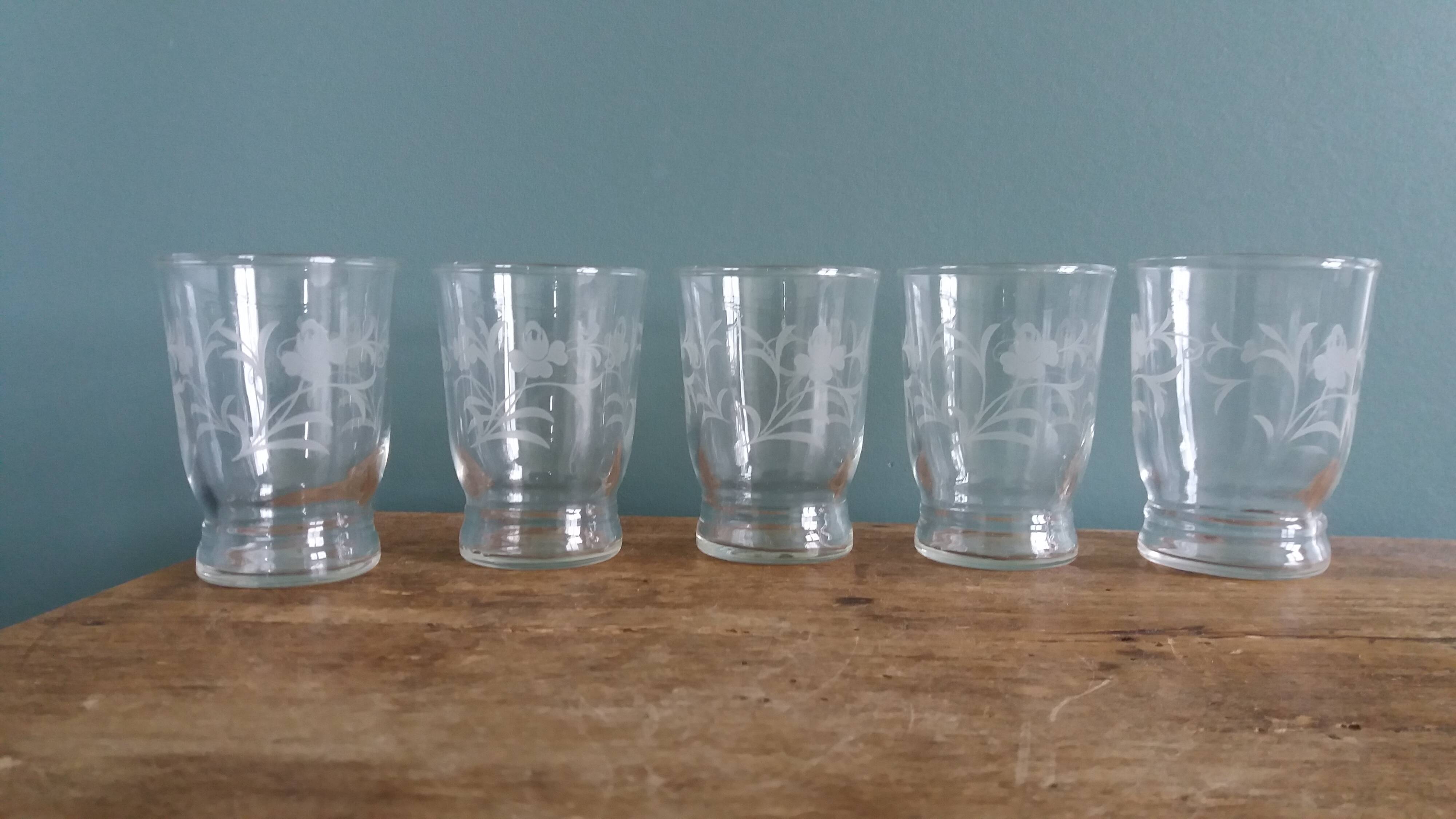 Old digestif or liqueur glasses, handcrafted glass with a floral pattern.