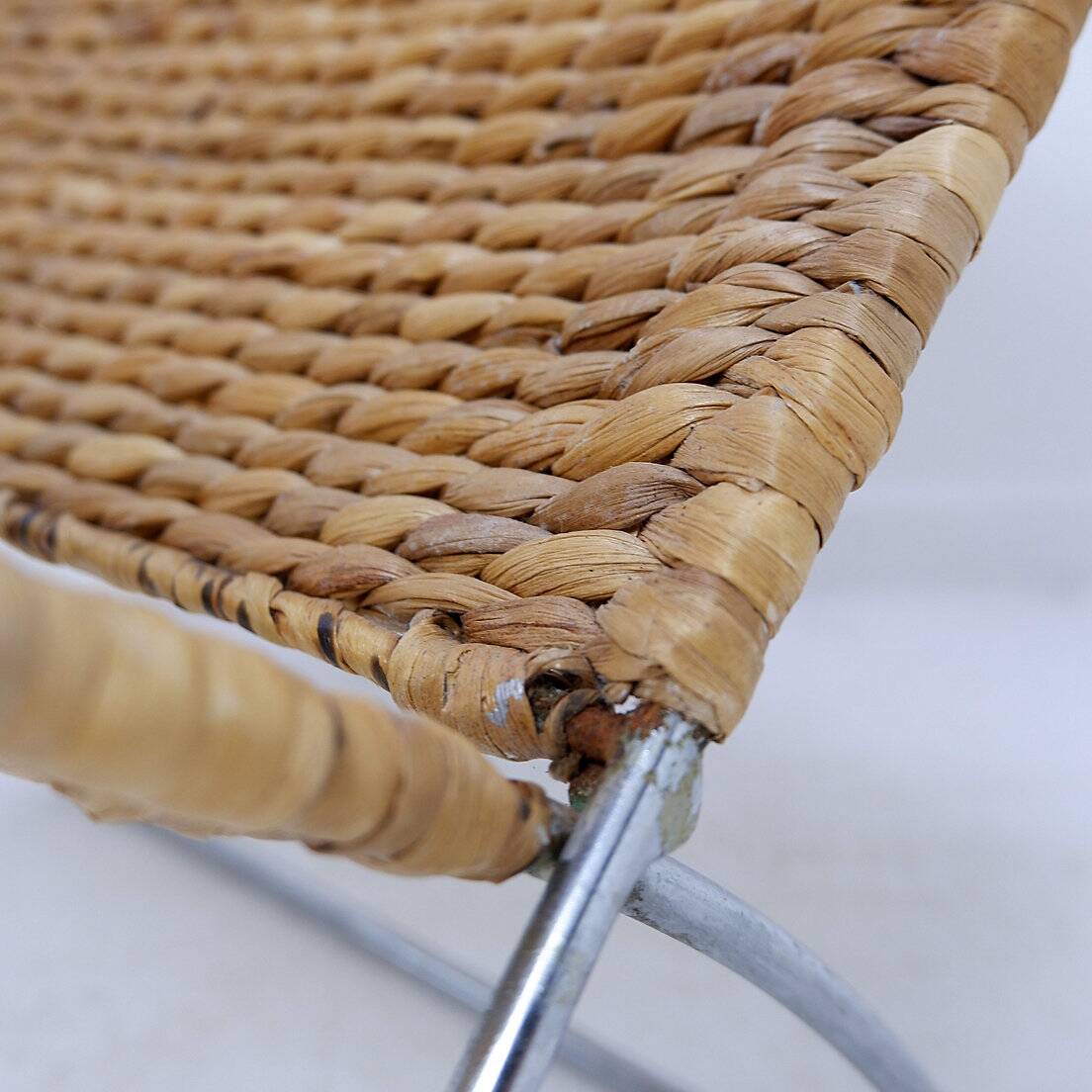 Chrome metal magazine rack with woven banana leaves