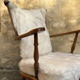 Scandinavian armchair in solid wood with beige fur cushion