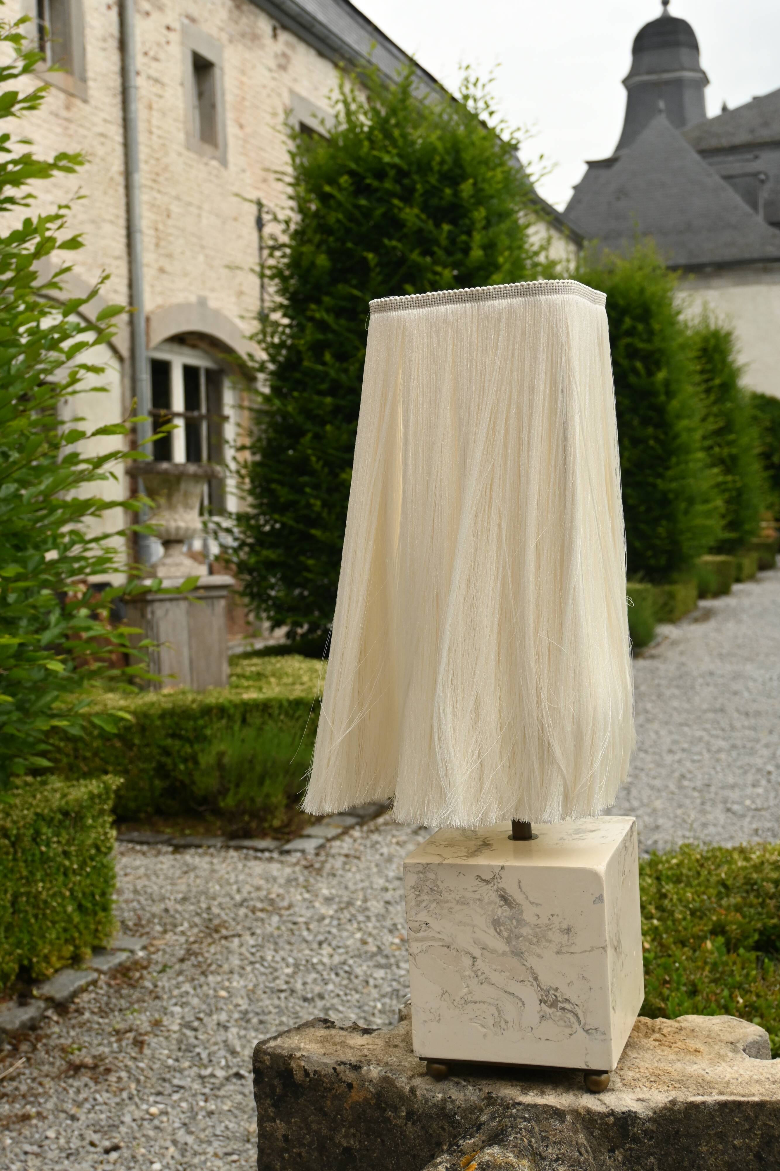Beige marble stucco base, Houles white ecru fringed lampshade.