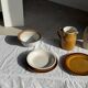 Small thick stoneware bowl with a stylised flower pattern in white on the outside, b