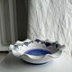 Small hand-painted earthenware salad bowl with garland of blue flowers, mark below