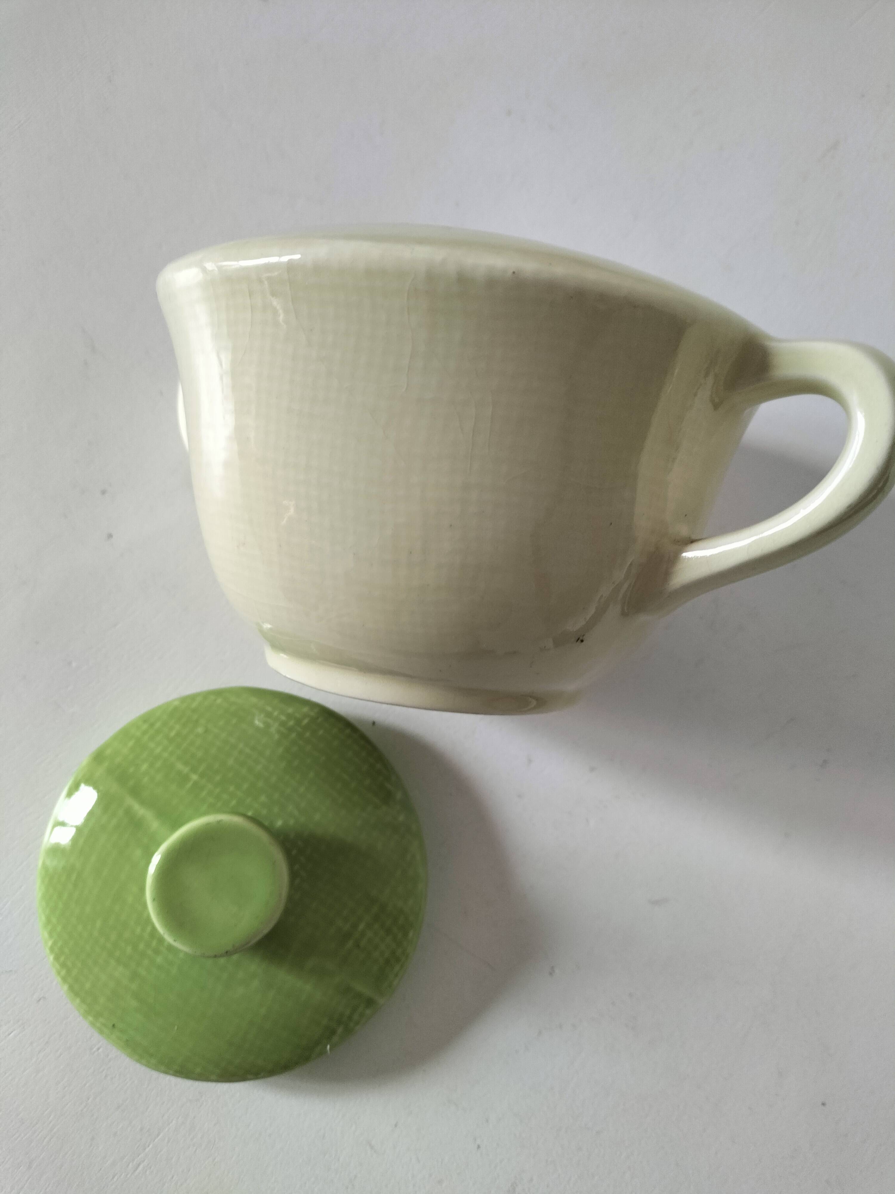 Two sugar bowls and a textured plate in turquoise and green Salins earthenware.