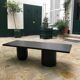 Rectangular coffee table in stained black wood with ball and cylindrical legs.