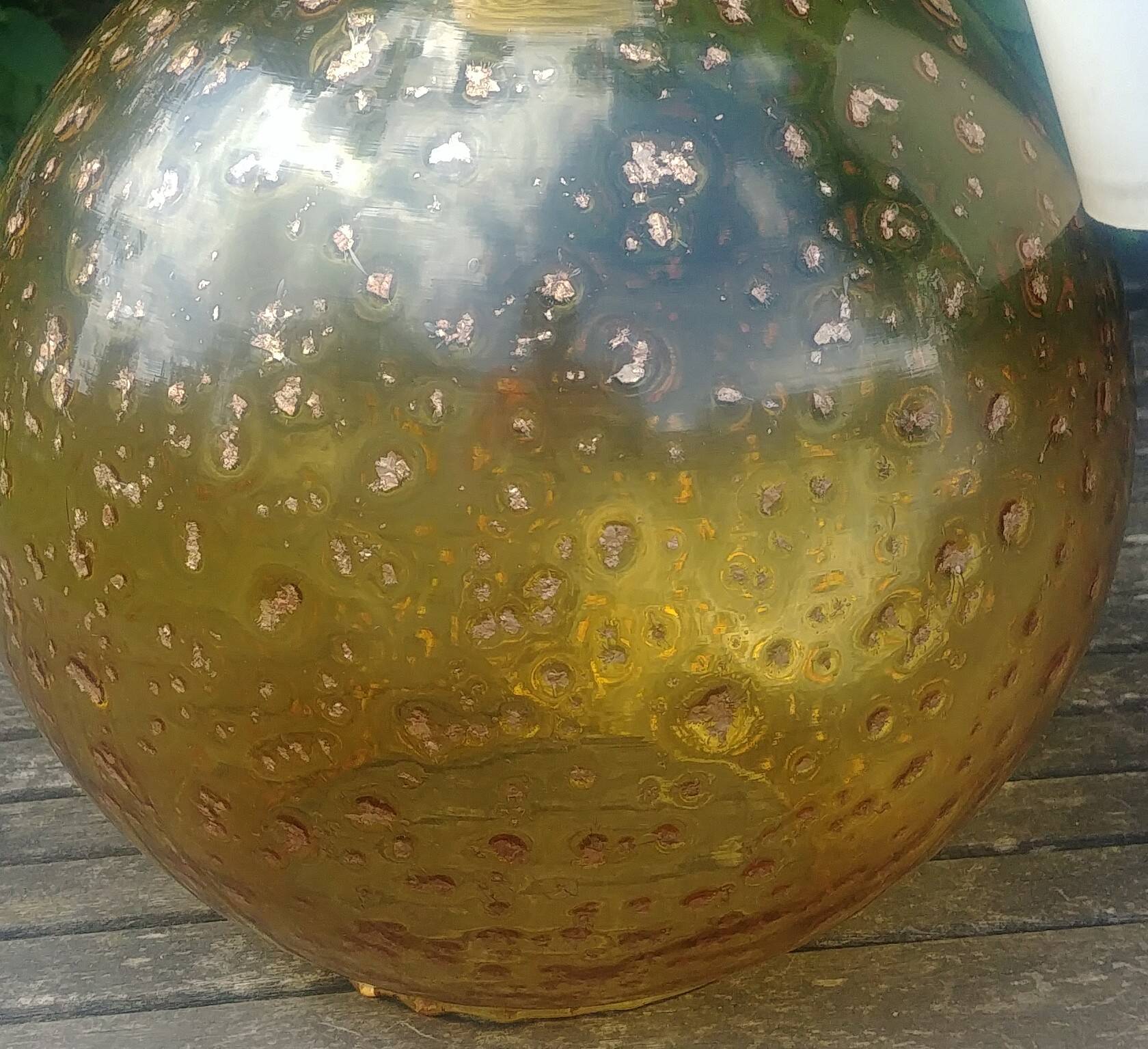 A vintage 70s blown glass pendant light with gold glitter in a globe shape