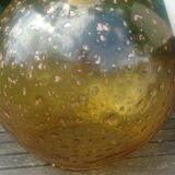 A vintage 70s blown glass pendant light with gold glitter in a globe shape