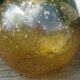 A vintage 70s blown glass pendant light with gold glitter in a globe shape