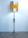 Floor lamp with a large orange shade and metal from the 1960s.
