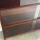 Vintage 1960s wooden library with sliding doors.