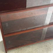 Vintage 1960s wooden library with sliding doors.