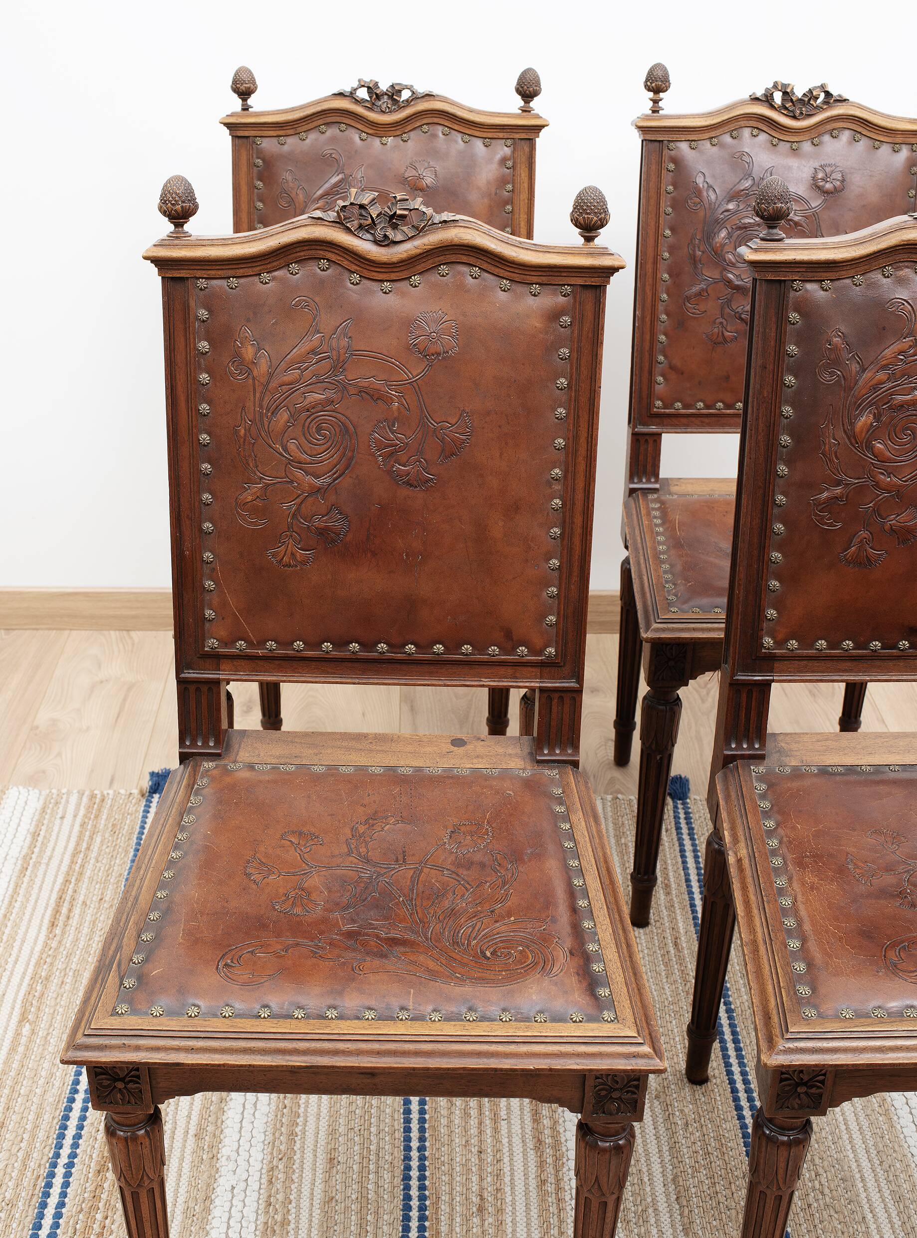 Set of 4 Louis XVI style chairs in carved wood and embossed leather.