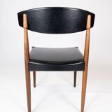 Set of four dining room chairs in rosewood and black leather of danish design from the 1960s.