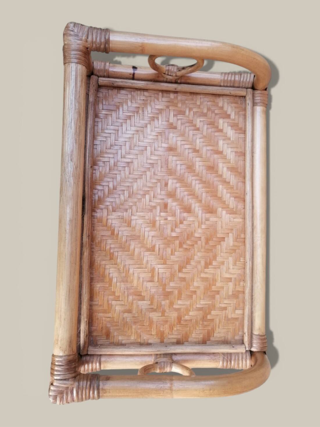 Small storage unit / freestanding shelf in light rattan.