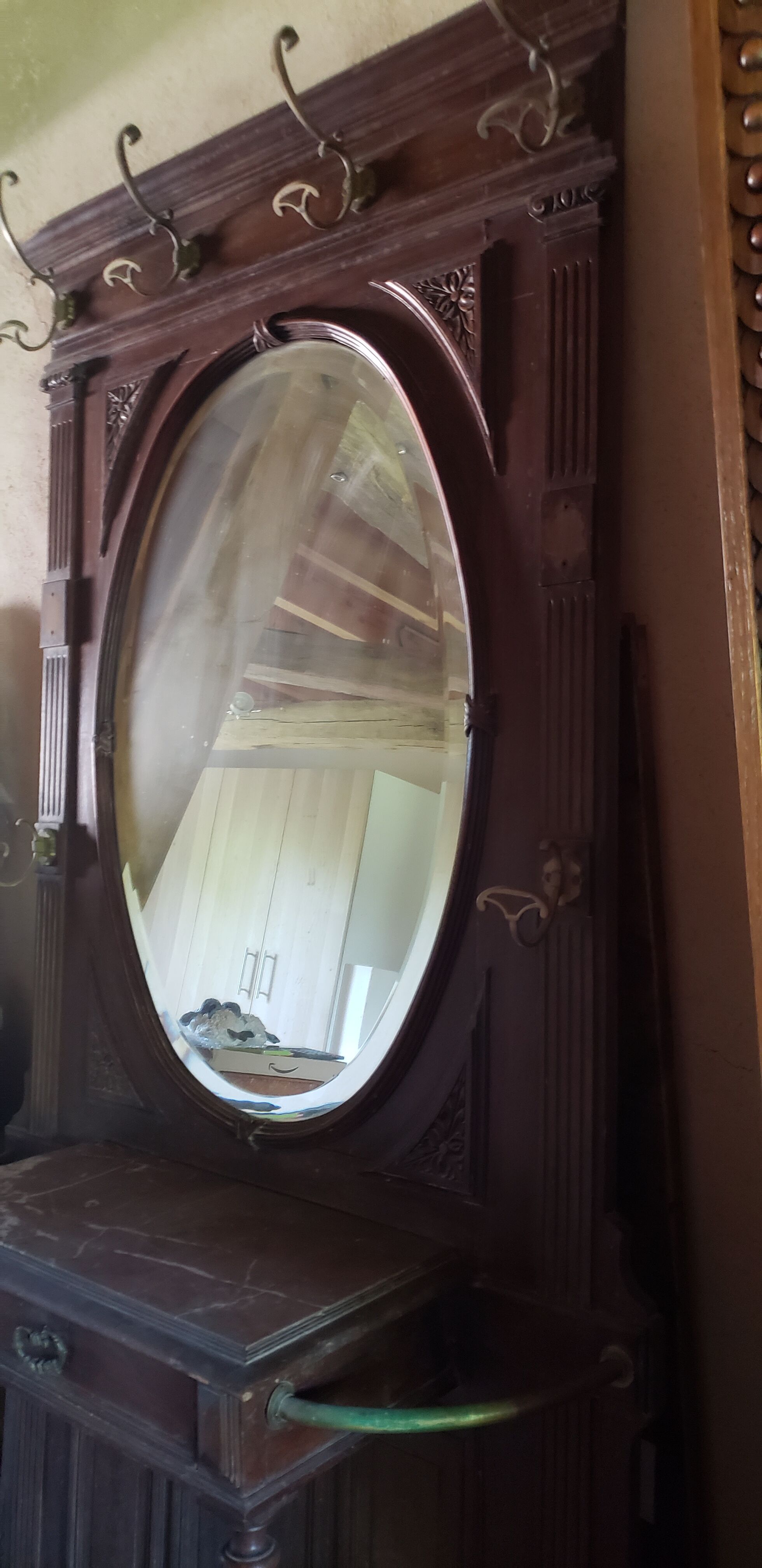 Coat rack with oval mirror