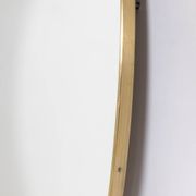 Oval shaped mirror set with a gilded brass rod. 1970s.