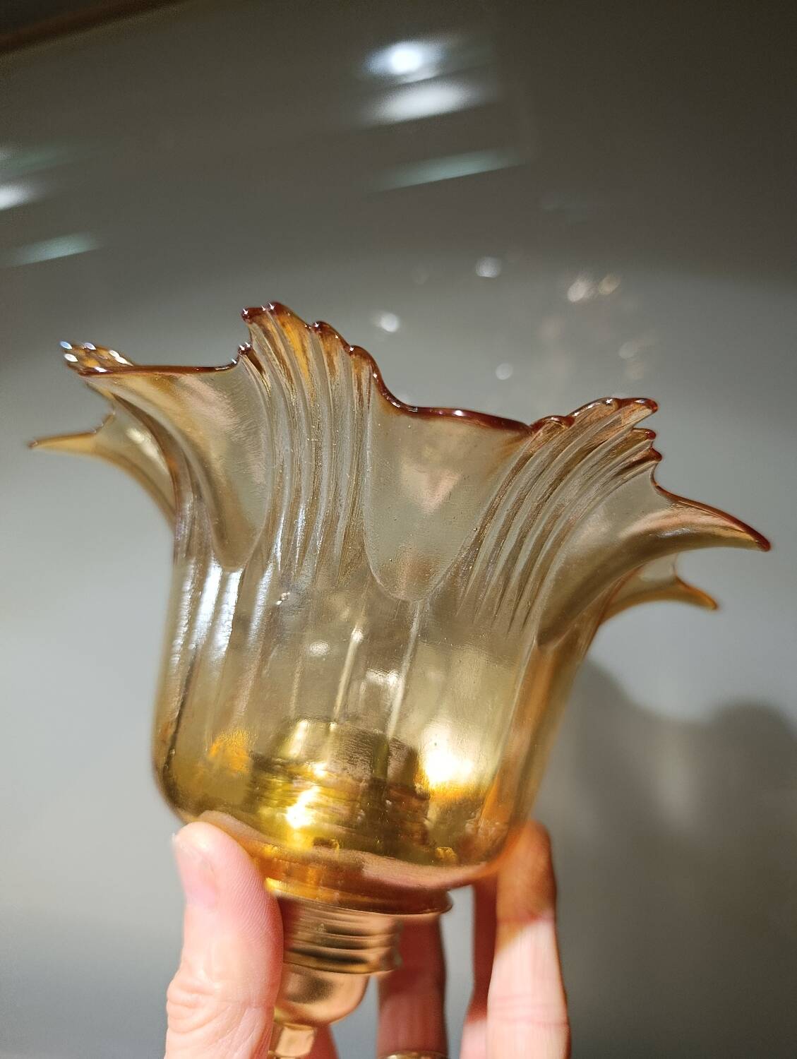 Amber tulip glass portable lamp, golden braided cord.