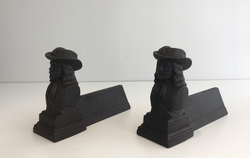 Pair of cast iron andirons in the likeness of a musketeer