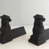 Pair of cast iron andirons in the likeness of a musketeer