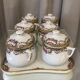 Suite de 6 pots à créme avec leur plateau en porcelaine de limoges