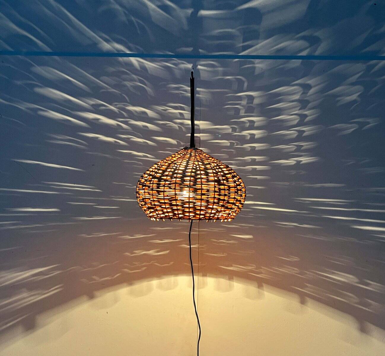 Mid-century modern Danish extendable cantilever wall lamp with a rattan shade, 1960s.
