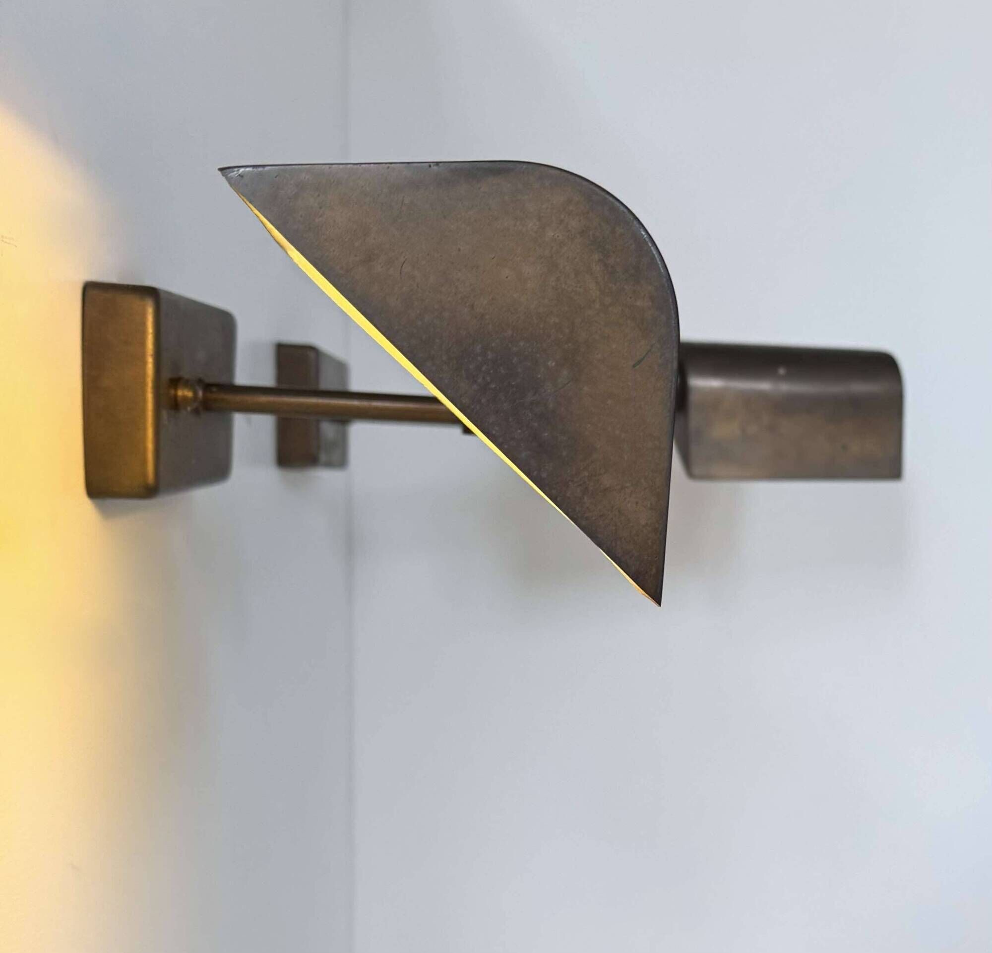 Pair of vintage adjustable wall lights, patinated brass, France 1970.