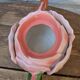 Ceramic teapot in the shape of a rose with a butterfly and raised petals.