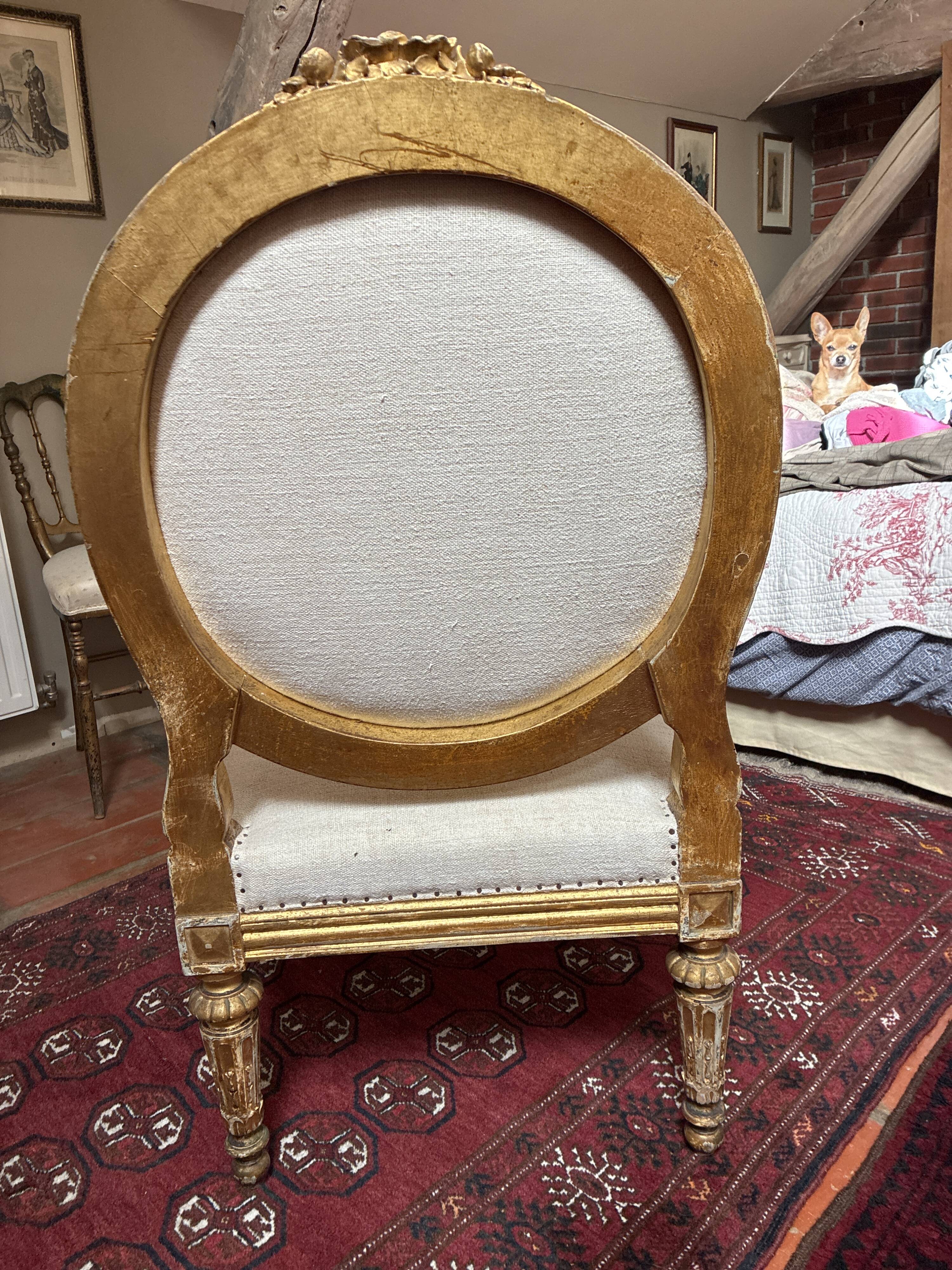 Large cabriolet armchair in Louis XVI style with gilded wood.