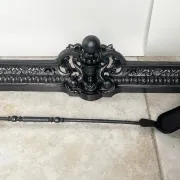 19th-century cast iron fireplace set, bar, andirons & plaque with griffins
