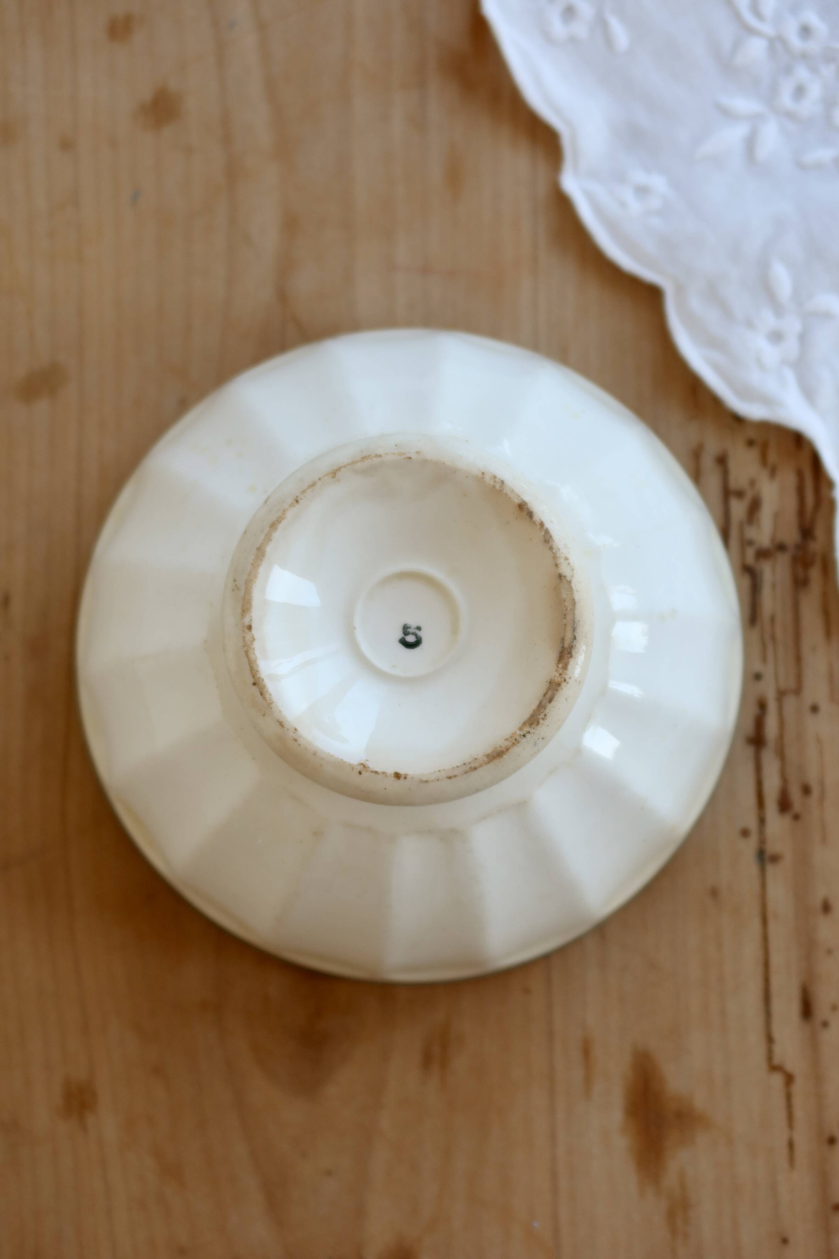 Old ivory ceramic bowl with double green trim.