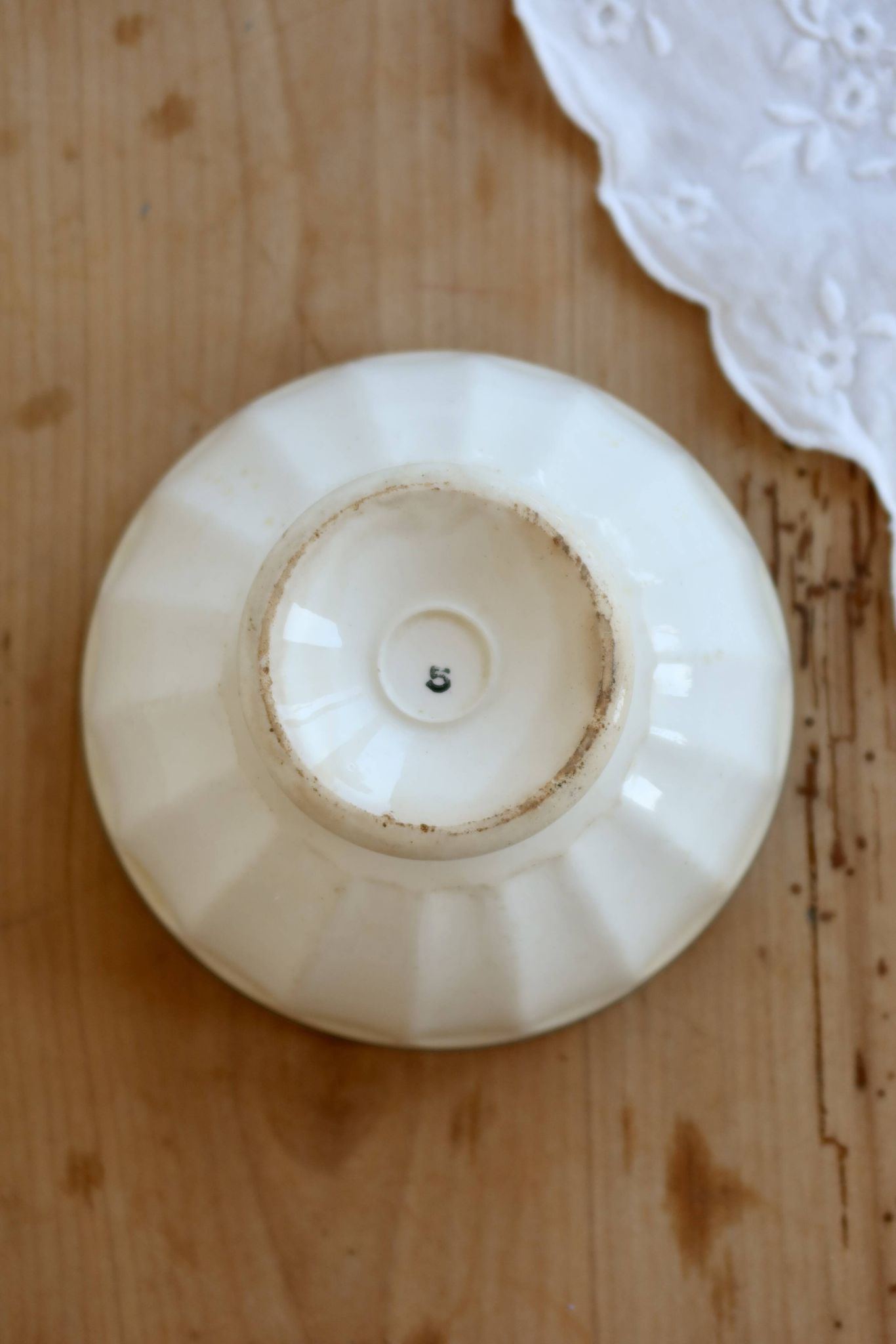 Old ivory ceramic bowl with double green trim.