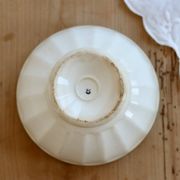 Old ivory ceramic bowl with double green trim.