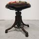 Antique curved wooden piano stool with kilim fabric from the 1910s.