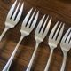 8 mismatched fish forks, silver metal