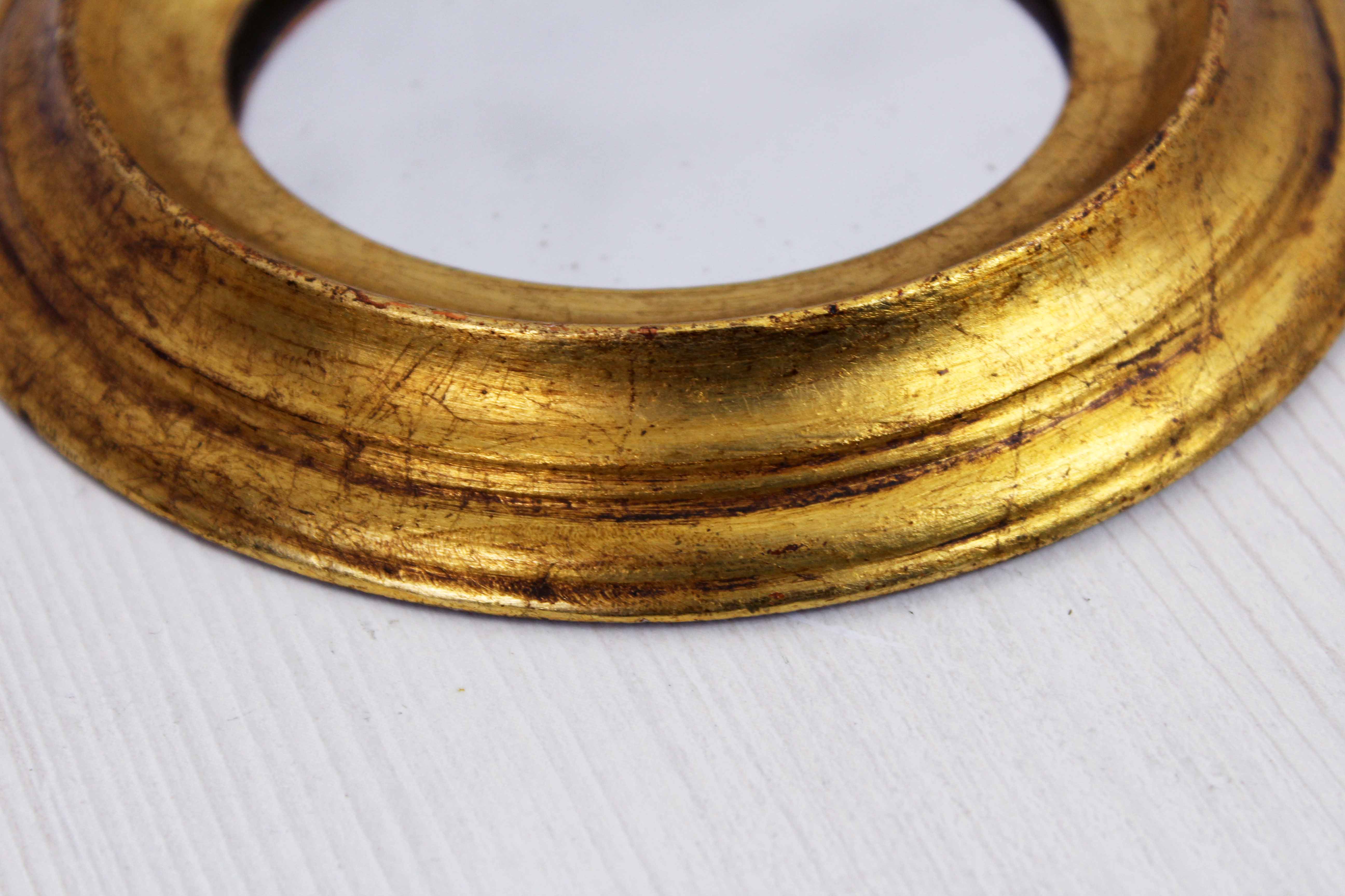 Golden oval mirror