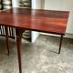 Folding table, dark wood console.