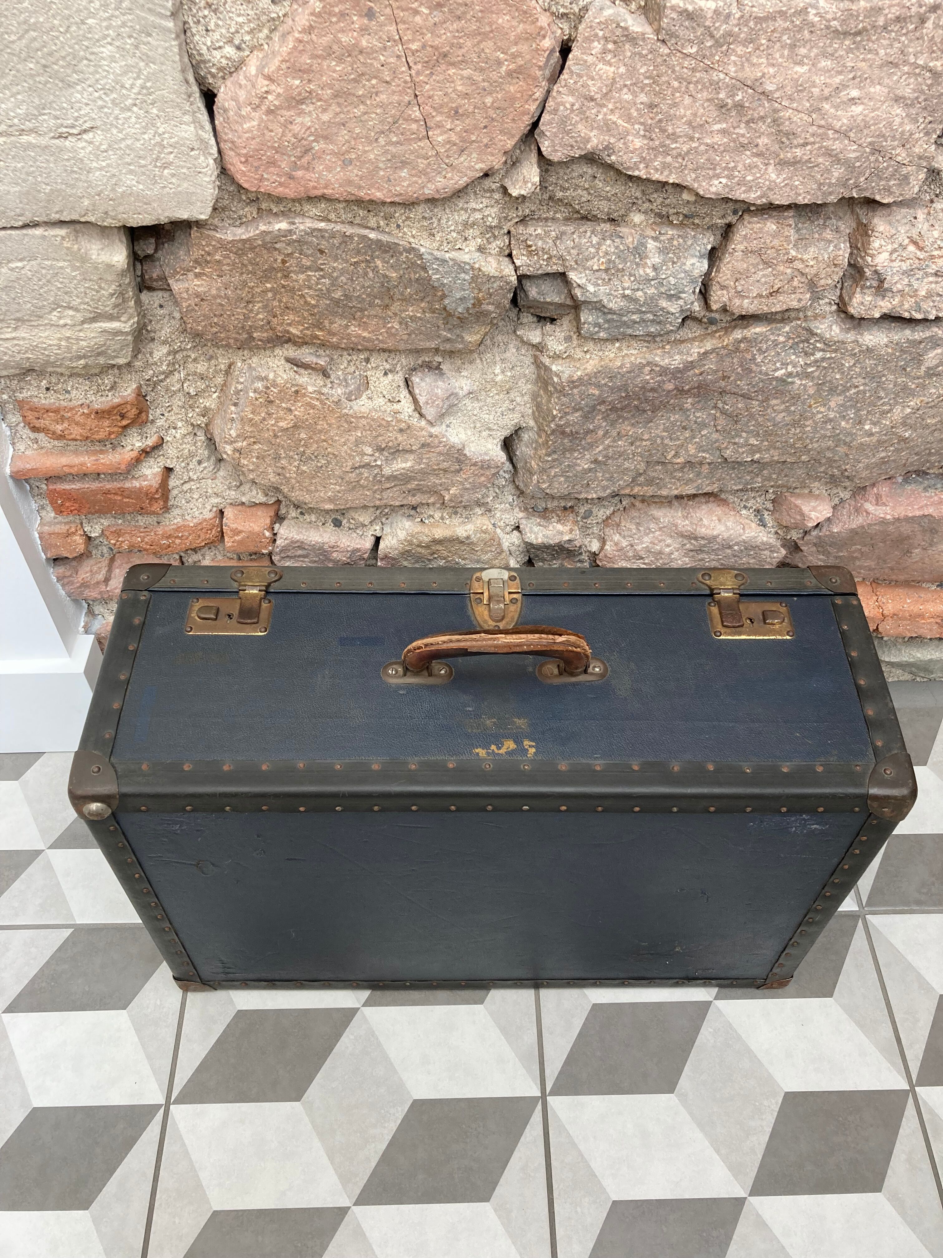 Midnight blue suitcase of representative 30s