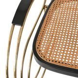 Modernist rocking chair in gilded brass and cane.