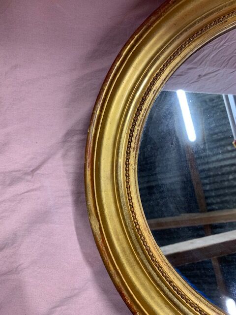 Golden oval mirror