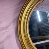 Golden oval mirror
