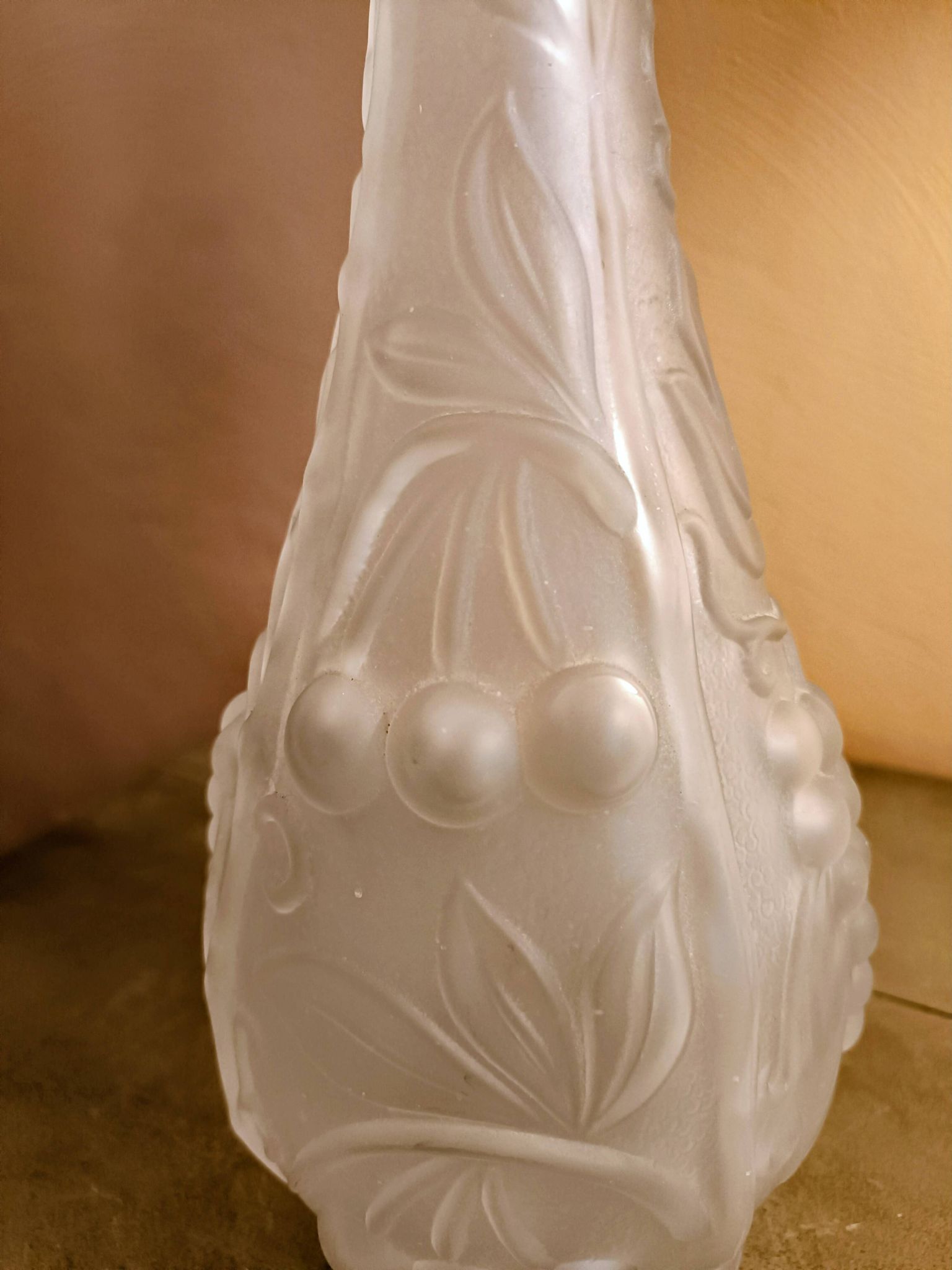 Frosted transparent glass carafe with raised cherry and grape patterns.