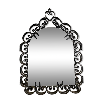 Old opening mirror with wrought iron shutters.