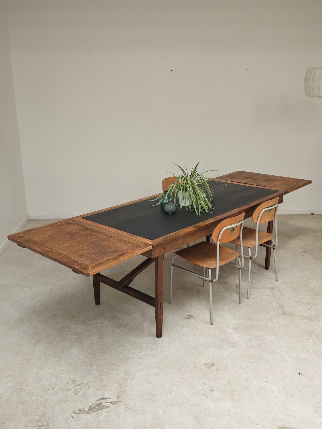 Vintage workshop folding table in oak with a hand-patinated black top.