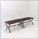 Set of 2 solid wood benches with an openwork design and wrought iron legs.