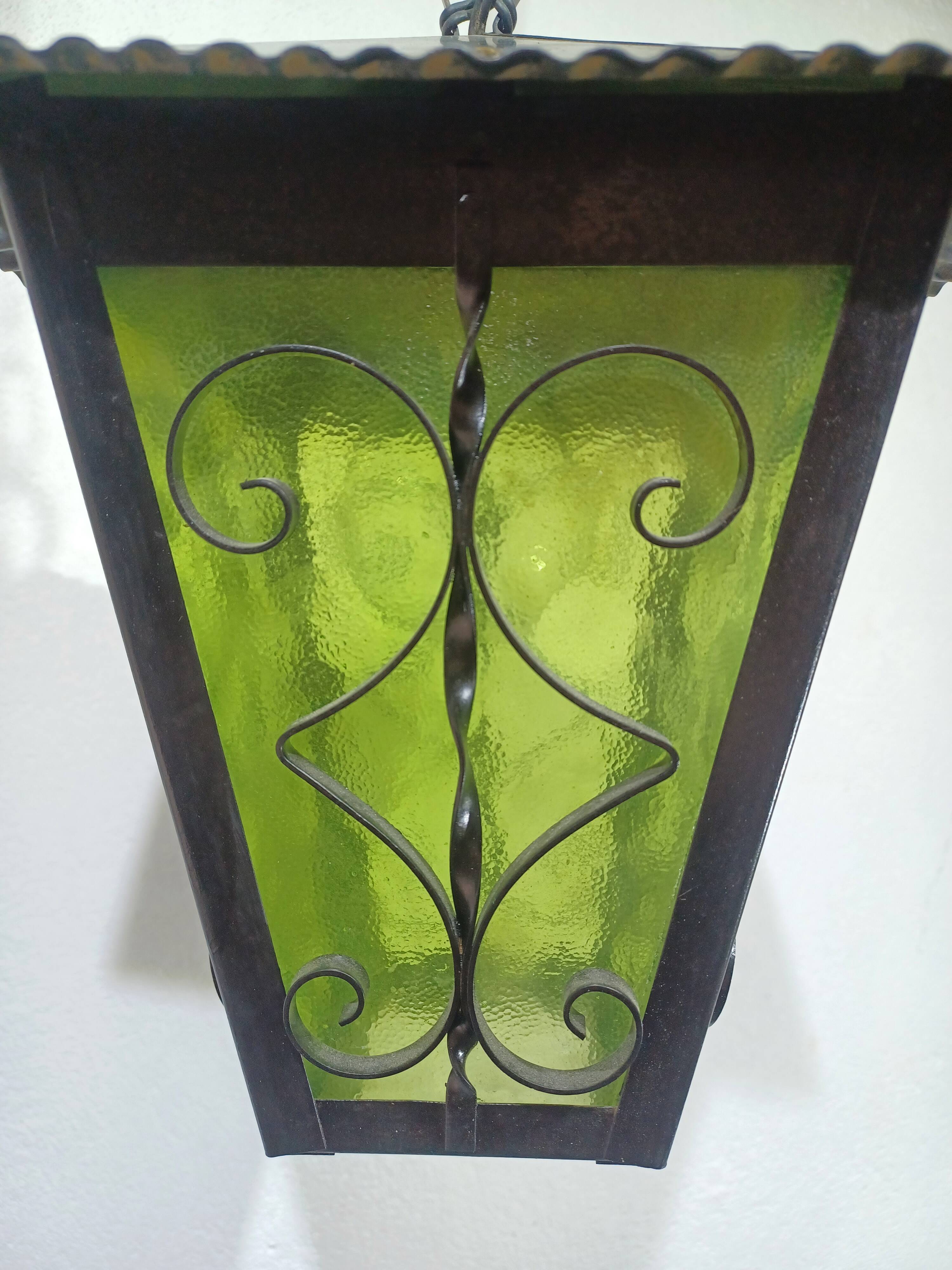 Wrought iron and green glass lantern