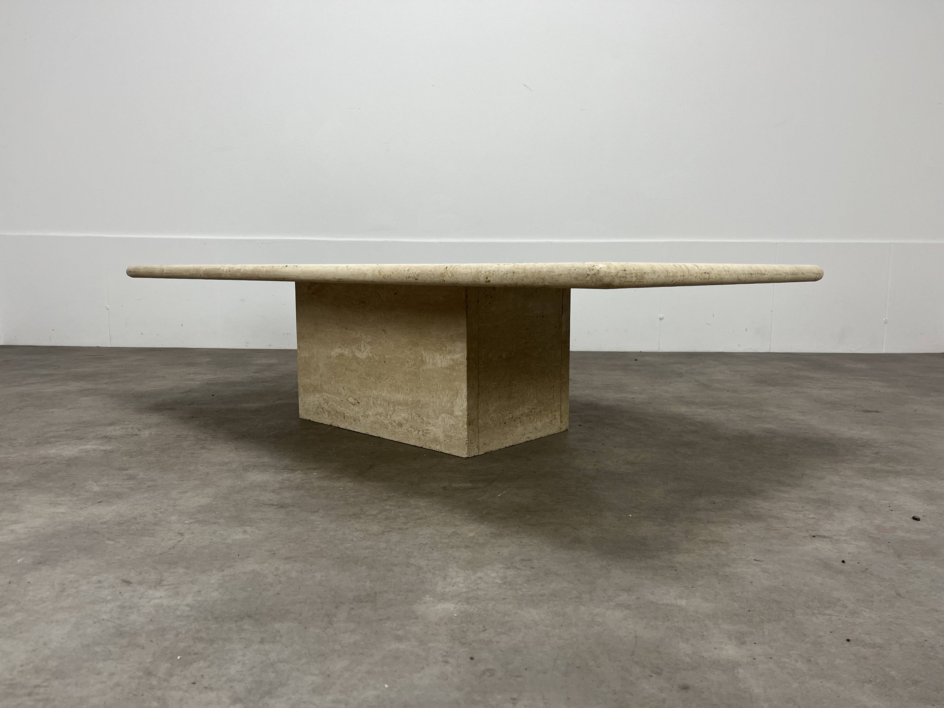 Rectangular travertine coffee table with central leg
