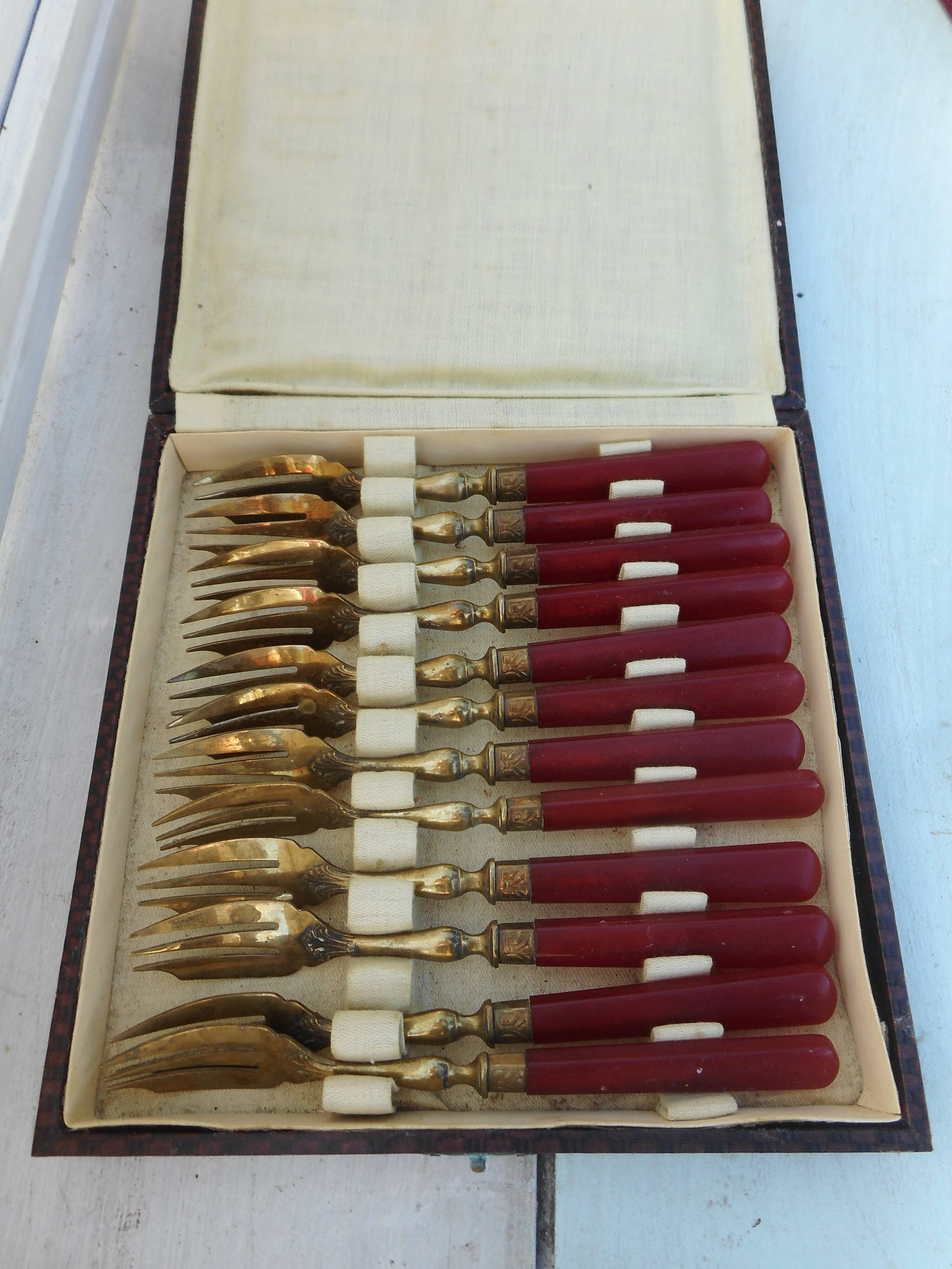 Twelve bakelite handle cake forks