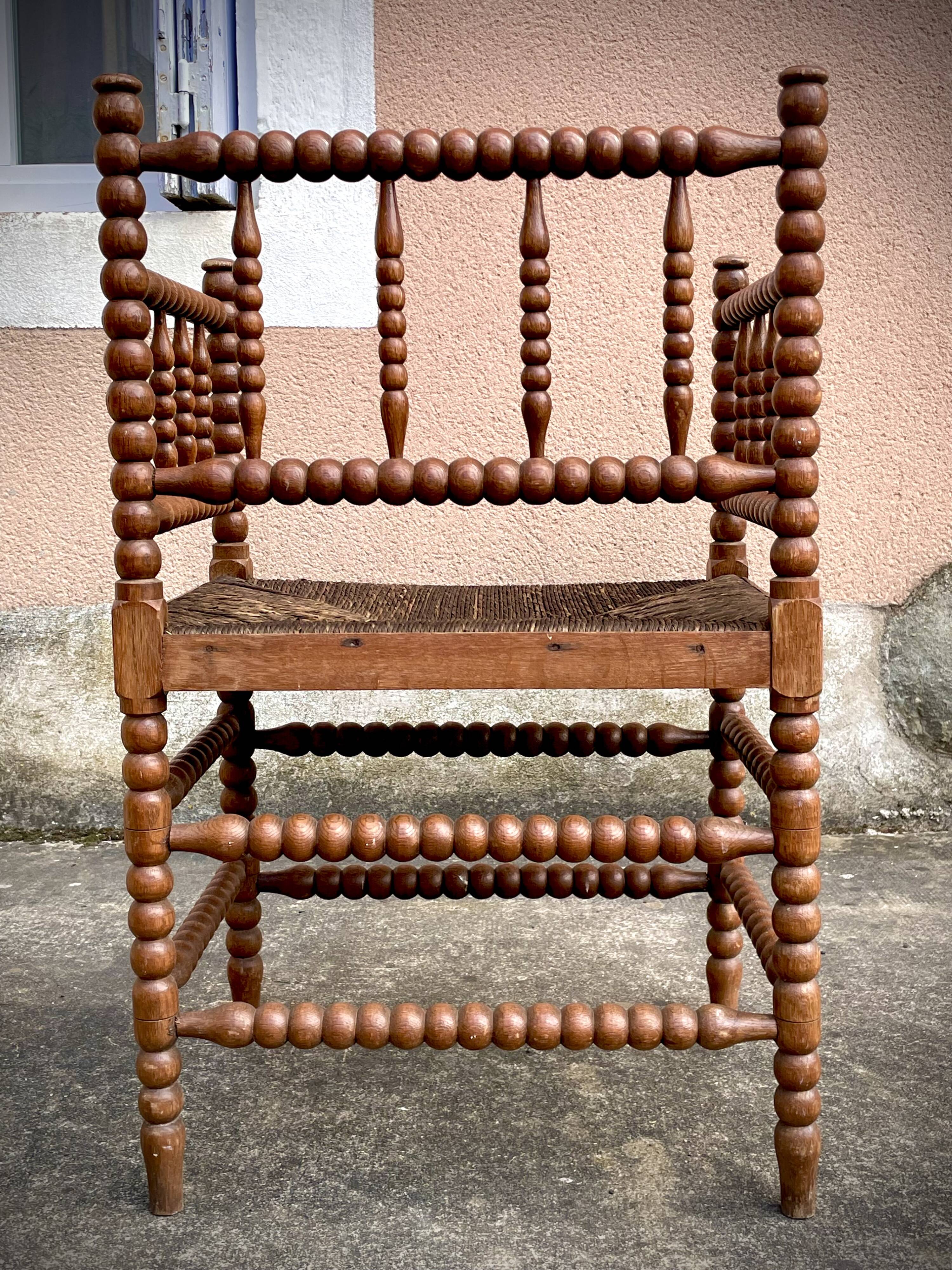 Antique Bobbin armchair with straw seat